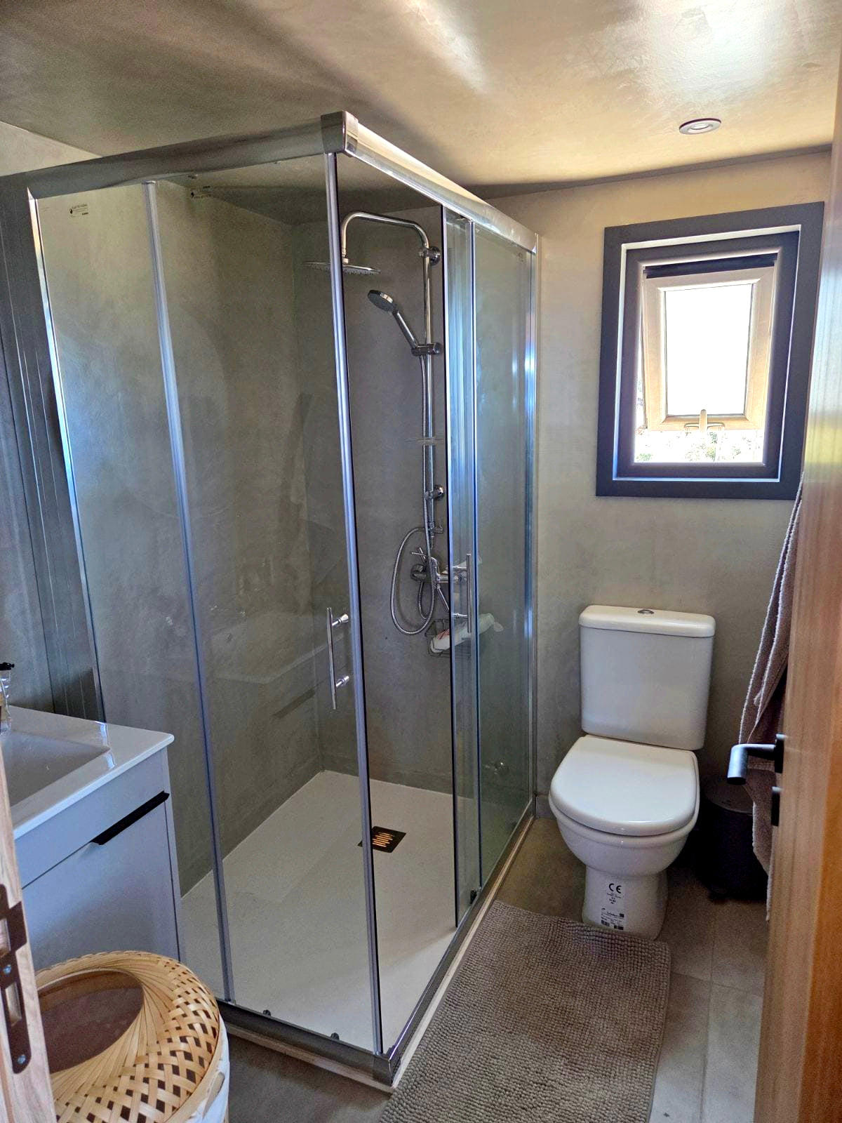 Bathroom with shower enclosure, toilet, and sink in a wooden cabin. Prefab house Cyprus. Prefabricated modular home Cyprus. Prefabcy. Buy modular home in Cyprus.