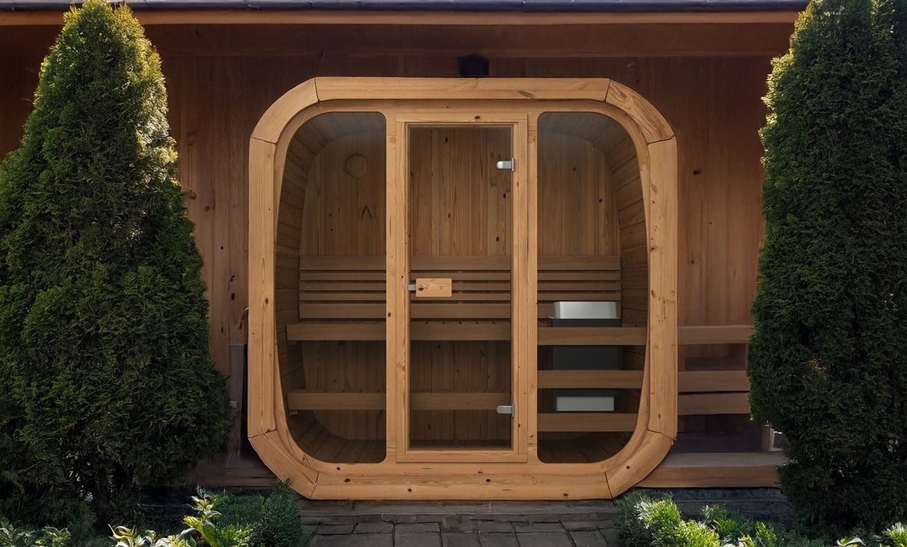 Wooden outdoor sauna with glass doors surrounded by greenery. Prefab house Cyprus. Prefabricated modular home Cyprus. Prefabcy. Buy modular home in Cyprus. Prefab sauna Cyprus. Modular sauna Cyprus
