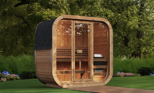 Wooden outdoor sauna in a garden setting with greenery. Prefab house Cyprus. Prefabricated modular home Cyprus. Prefabcy. Buy modular home in Cyprus. Prefab sauna Cyprus. Modular sauna Cyprus